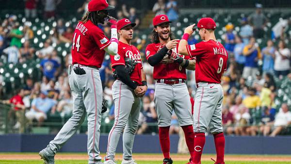 Reds hang on to beat Milwaukee, trail by half-game in NL Central